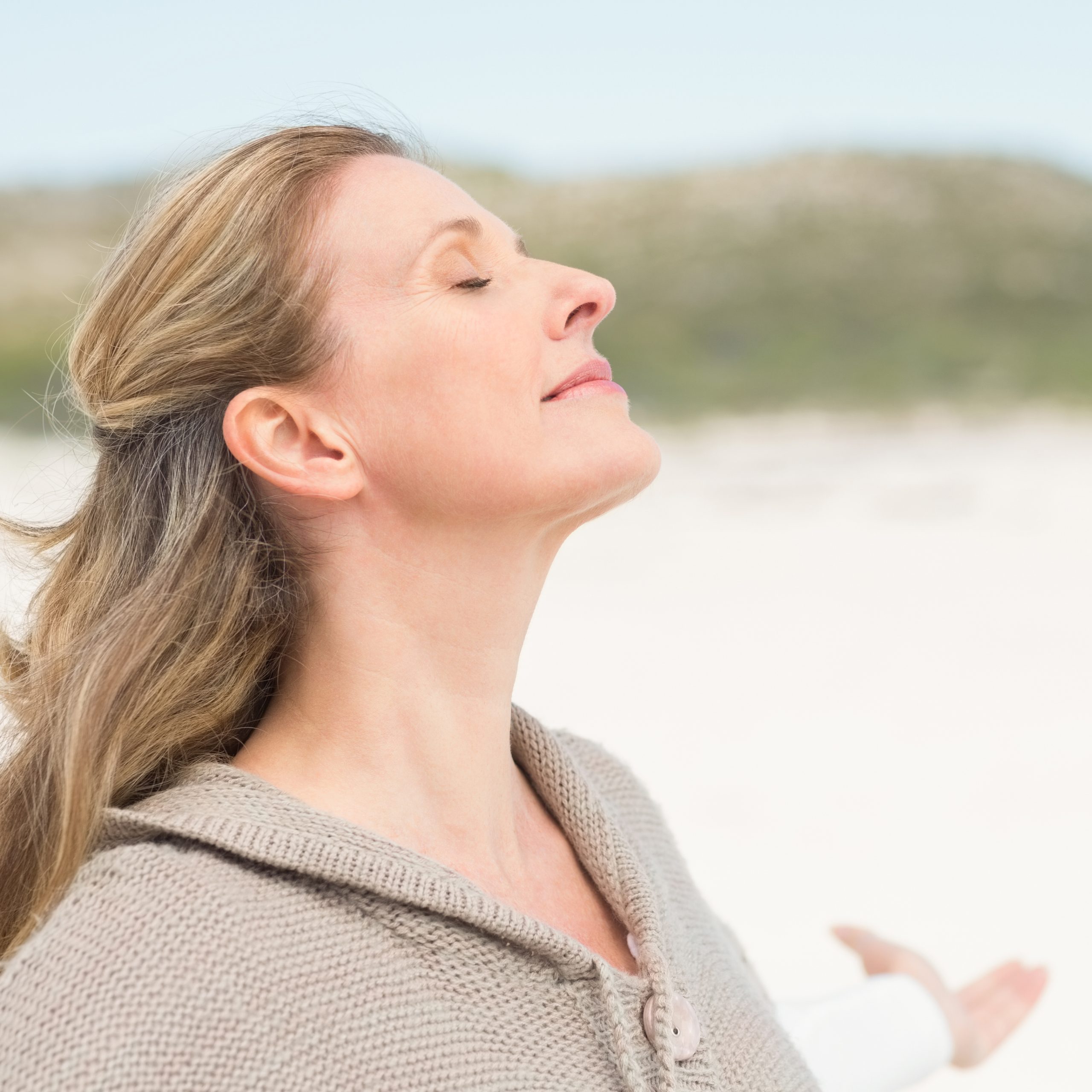 smiling-woman-letting-her-hair-down-at-the-beach-2